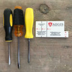 three screw drivers with door gauge